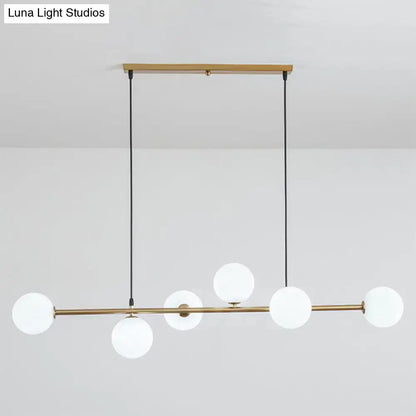 Modern gold metal island pendant with blue glass spheres dining room