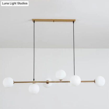 Modern gold metal island pendant with blue glass spheres dining room