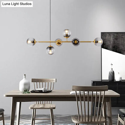 Modern gold metal island pendant with blue glass spheres dining room