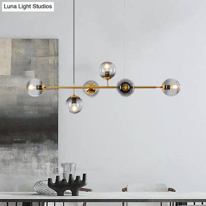 Modern gold metal island pendant with blue glass spheres dining room