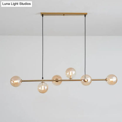 Modern gold metal island pendant with blue glass spheres dining room