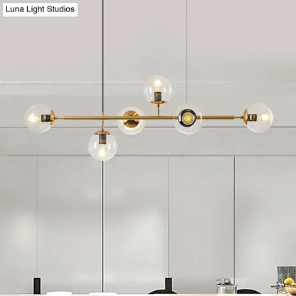 Modern gold metal island pendant with blue glass spheres dining room