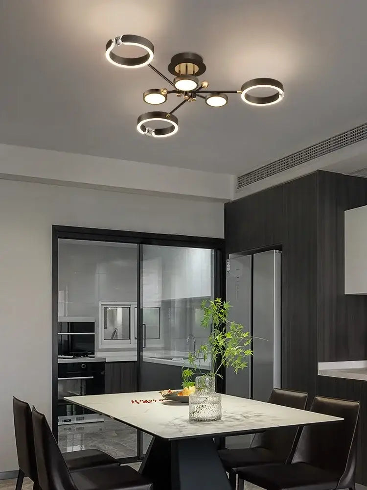 Modern gold plated chandelier with black arms for living room