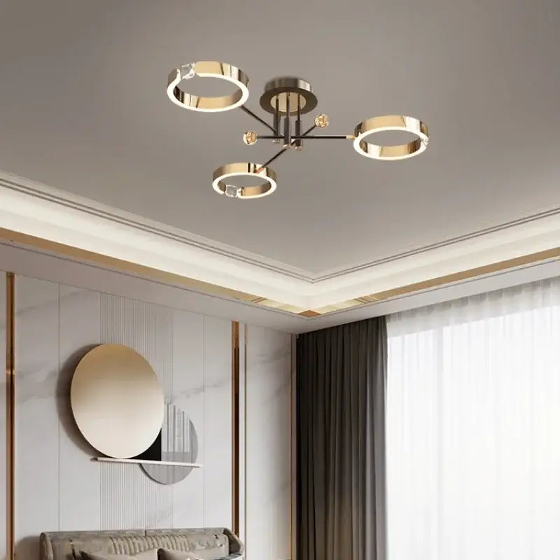 Modern gold plated chandelier with black arms for living room