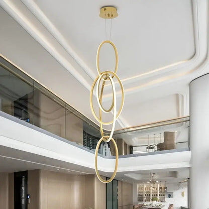 Modern gold steel pendant light interlocking rings dining room