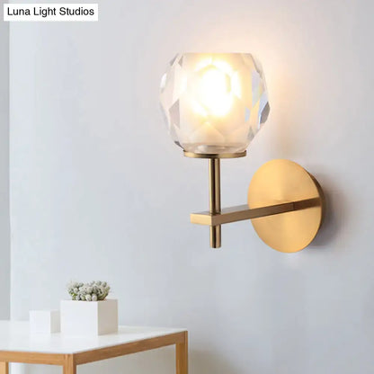 Modern gold wall lamp with faceted globe shade for hallway