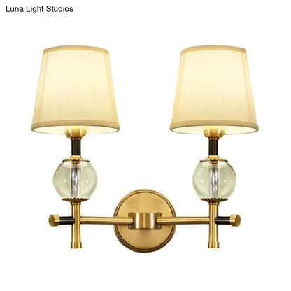 Modern gold wall light with crystal and fabric shade bedroom
