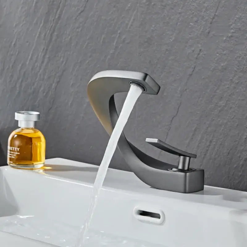 Modern gold & white bathroom basin faucet with curved spout