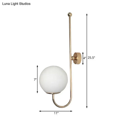 Modern golden gooseneck wall sconce with frosted glass ball bedroom