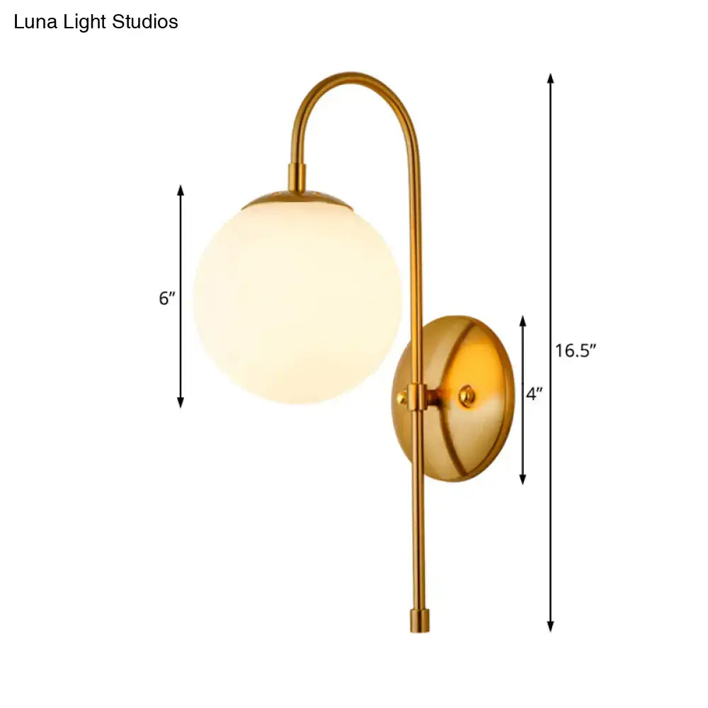 Modern golden gooseneck wall sconce with frosted glass ball bedroom