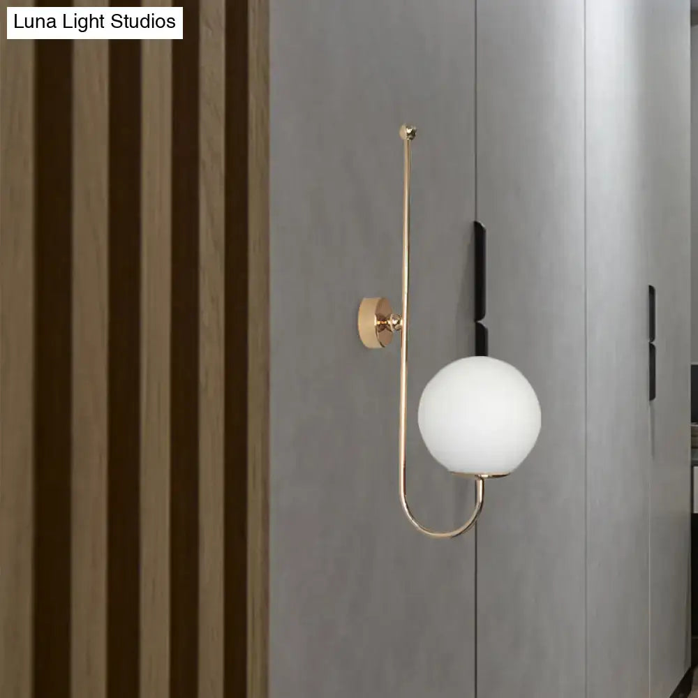 Modern golden gooseneck wall sconce with frosted glass ball bedroom