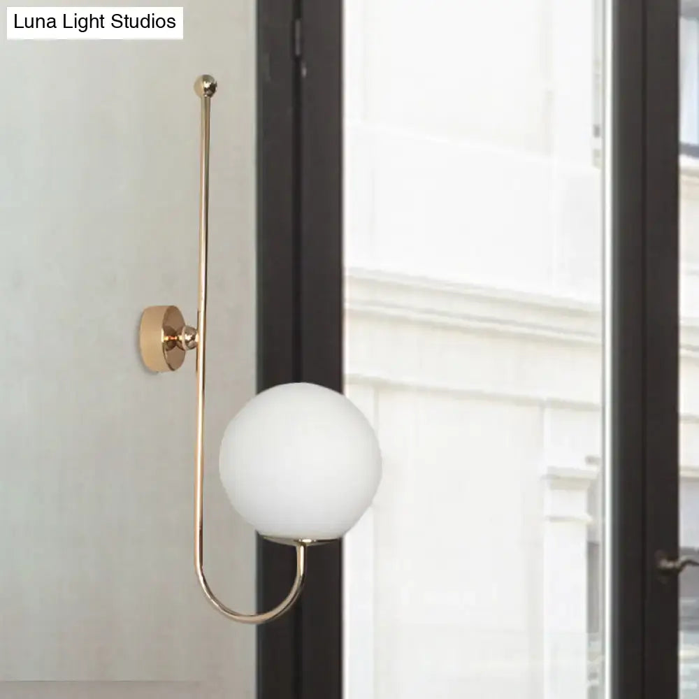 Modern golden gooseneck wall sconce with frosted glass ball bedroom
