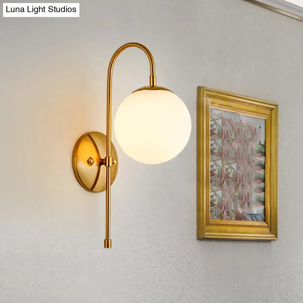 Modern golden gooseneck wall sconce with frosted glass ball bedroom