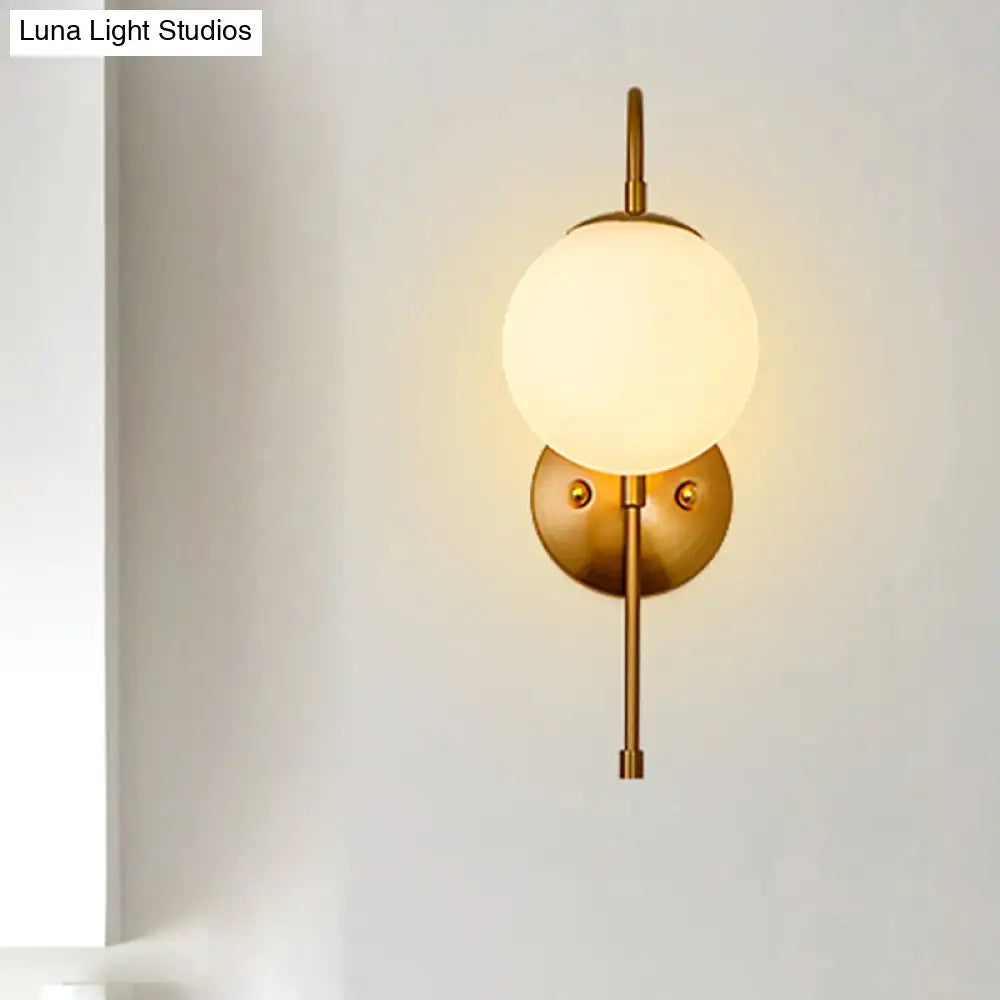Modern golden gooseneck wall sconce with frosted glass ball bedroom