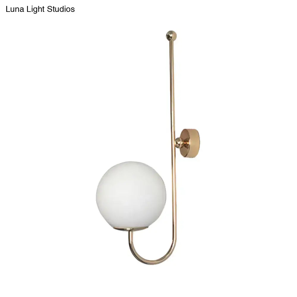 Modern golden gooseneck wall sconce with frosted glass ball bedroom