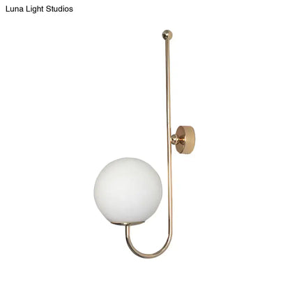 Modern golden gooseneck wall sconce with frosted glass ball bedroom