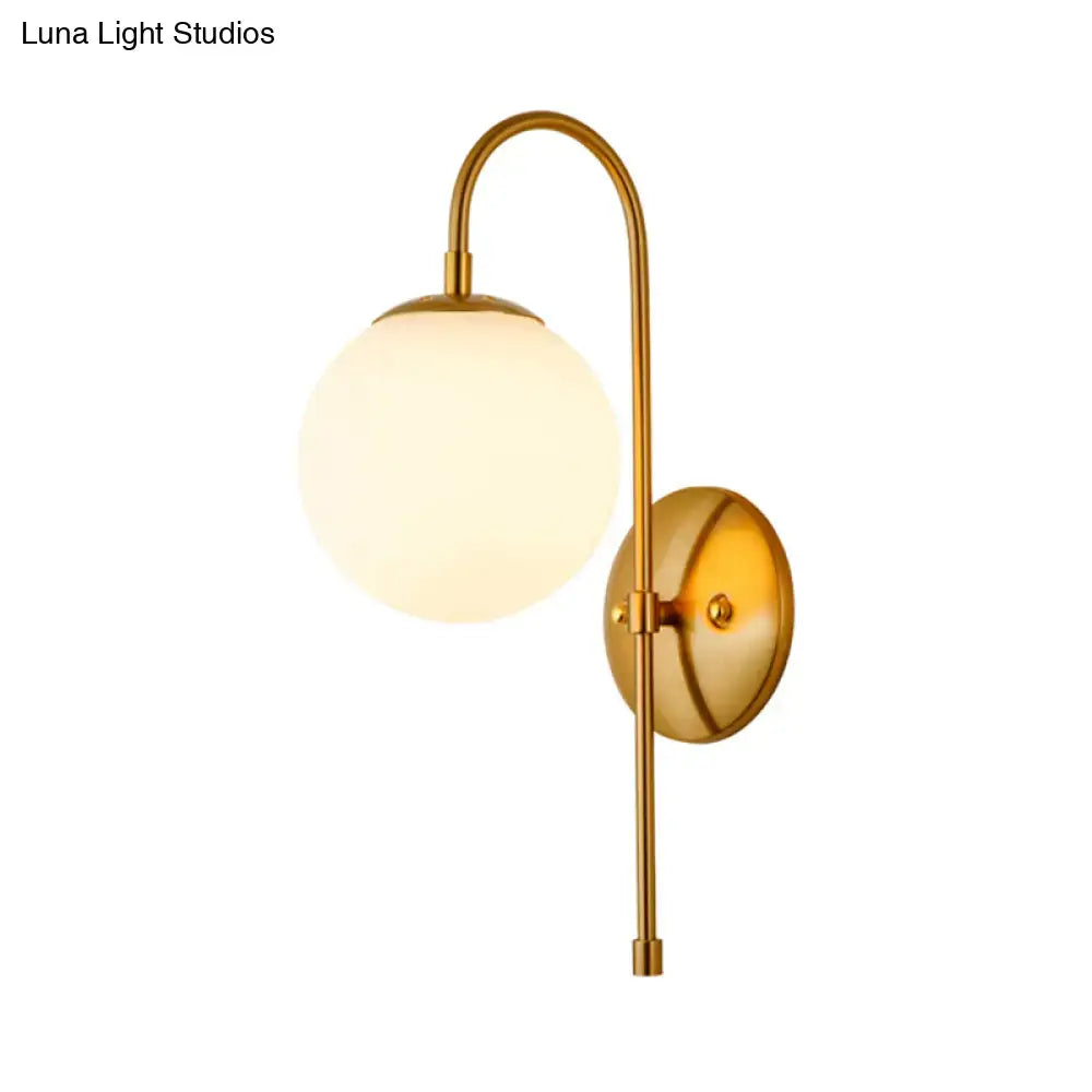 Modern golden gooseneck wall sconce with frosted glass ball bedroom
