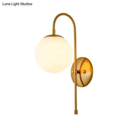 Modern golden gooseneck wall sconce with frosted glass ball bedroom