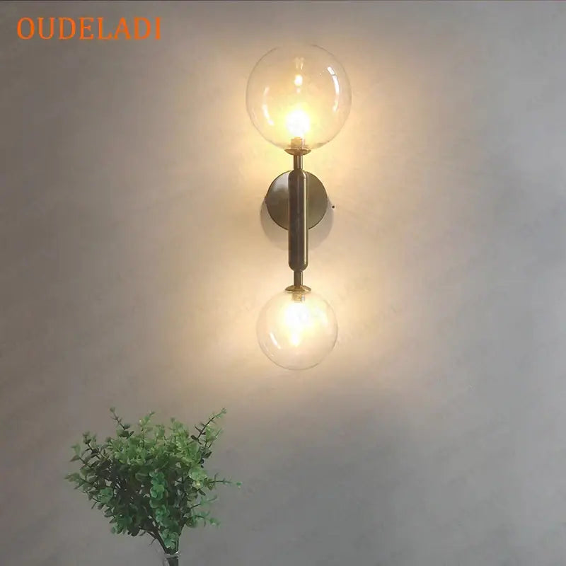Modern golden led wall sconce with milky glass globes for bedroom