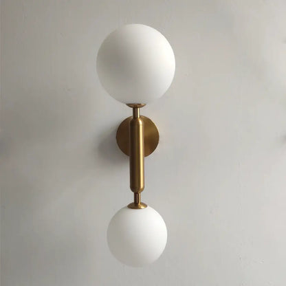 Modern golden led wall sconce with milky glass globes for bedroom
