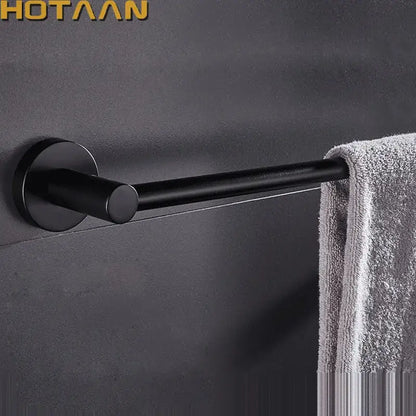 Modern matte black wall mounted towel bar with wood accents bathroom
