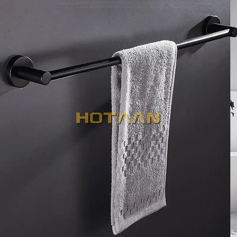 Modern matte black wall mounted towel bar with wood accents bathroom
