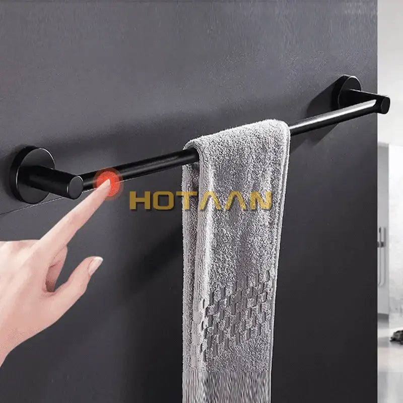 Modern matte black wall mounted towel bar with wood accents bathroom