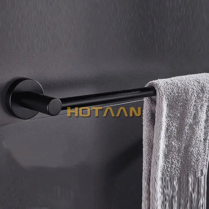Modern matte black wall mounted towel bar with wood accents bathroom