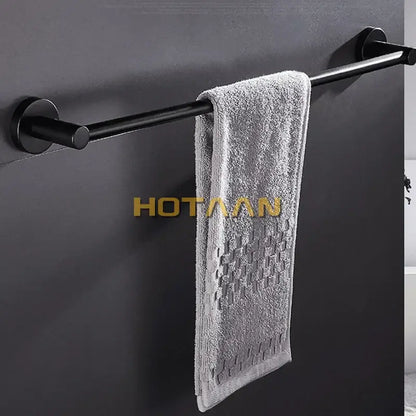 Modern matte black wall mounted towel bar with wood accents bathroom