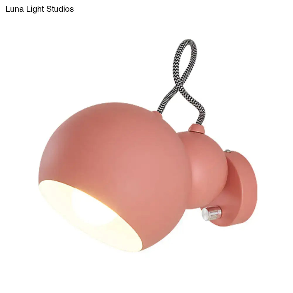 Modern pink spherical wall lamp with flexible black cord living room
