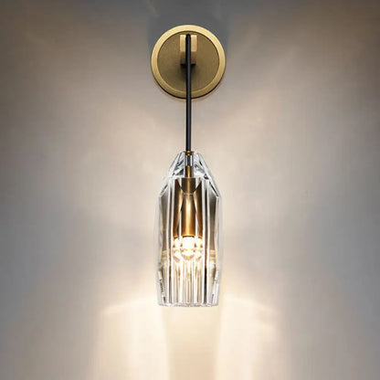 Modern single light brass wall sconce with clear crystal for bedroom