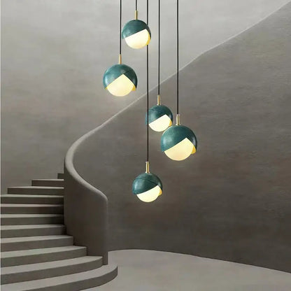 Modern teal glass and brass pendant light for kitchen island