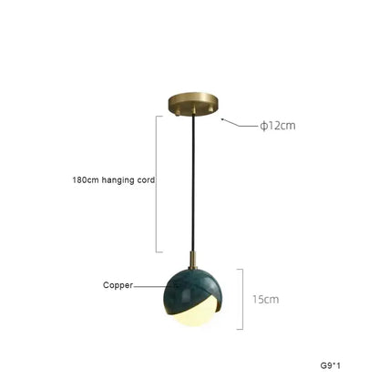 Modern teal glass and brass pendant light for kitchen island