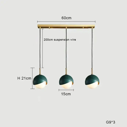 Modern teal glass and brass pendant light for kitchen island