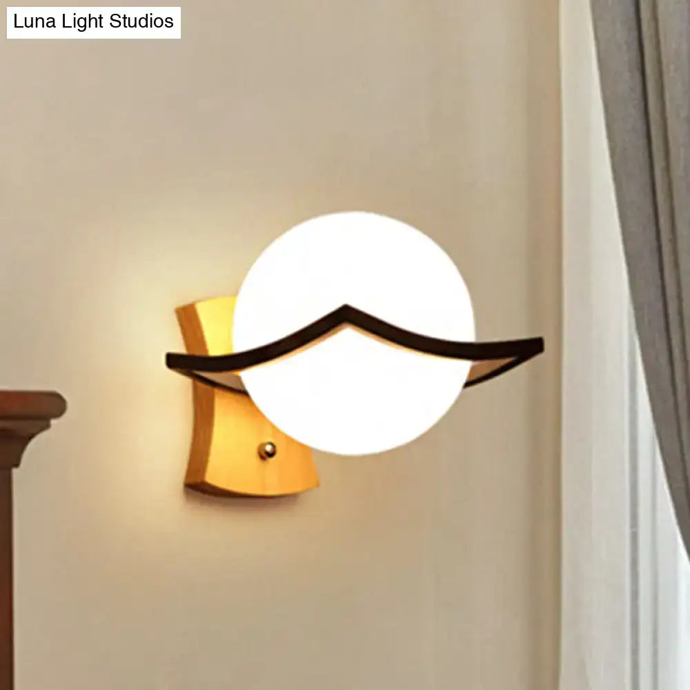 Modern white glass ball sconce with black accent for bedroom