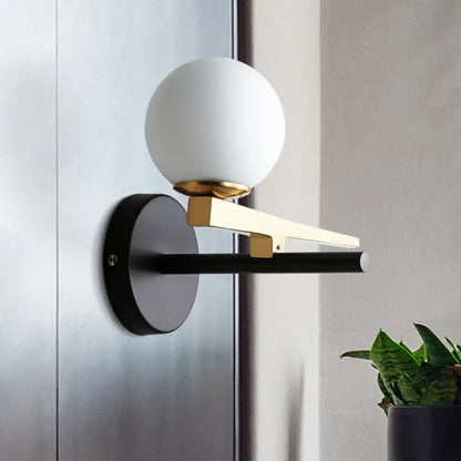 Modern white glass sphere wall light gold & black single light bedroom