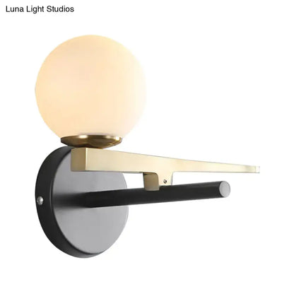 Modern white glass sphere wall light gold & black single light bedroom