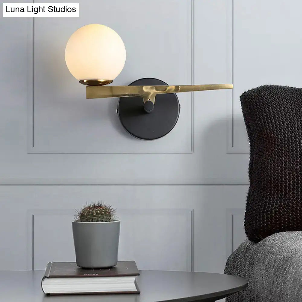 Modern white glass sphere wall light gold & black single light bedroom