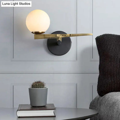 Modern white glass sphere wall light gold & black single light bedroom