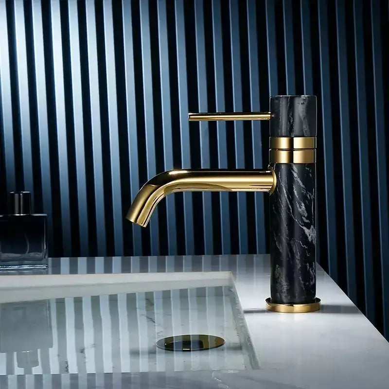 Modern white marble and brushed gold bathroom faucet with swivel spout