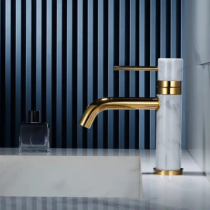 Modern white marble and brushed gold bathroom faucet with swivel spout
