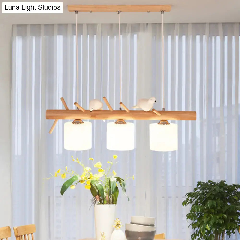 Modern wood cylinder hanging light with birds white glass kitchen