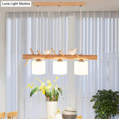 Modern wood cylinder hanging light with birds white glass kitchen