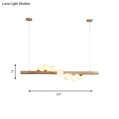 Modern wood island light with opal glass spheres for dining room