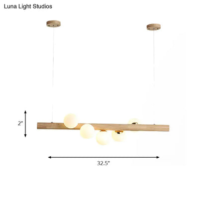 Modern wood island light with opal glass spheres for dining room
