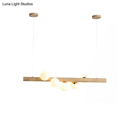 Modern wood island light with opal glass spheres for dining room
