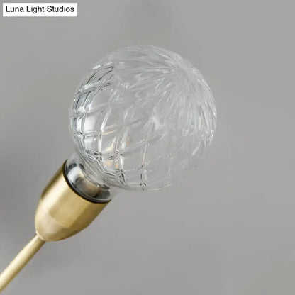 Modernist brass wall mount light fixture with prismatic glass bedroom