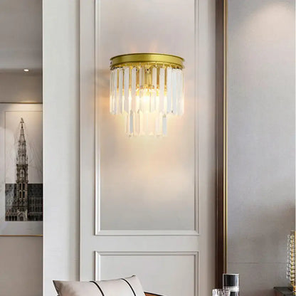Modernist gold wall lamp with clear faceted crystal for living room