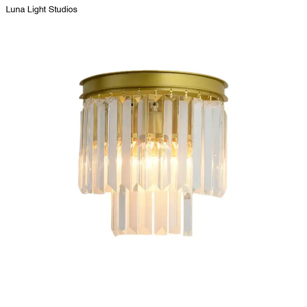 Modernist gold wall lamp with clear faceted crystal for living room