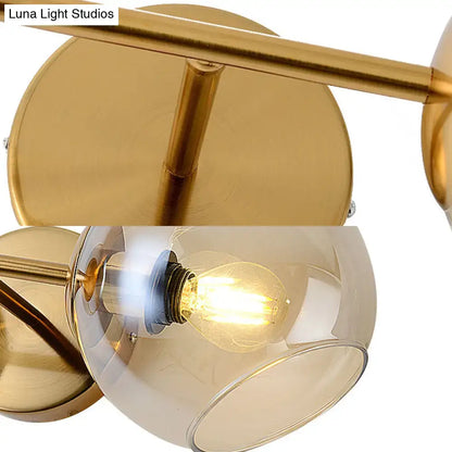 Modernist gold wall lamp with glass shade for living room